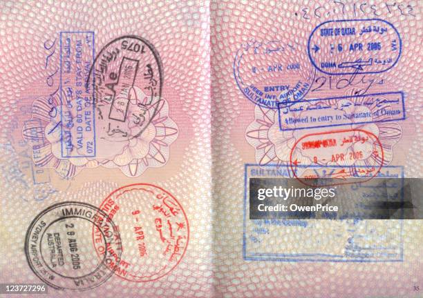 an opened passport with entry stamps on both pages - australia passport stockfoto's en -beelden