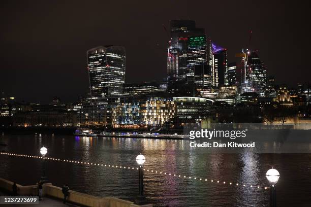 General view of the City of London skyline at night following the announcement of an interest rate rise to 0.25% by the Bank of England, on December...