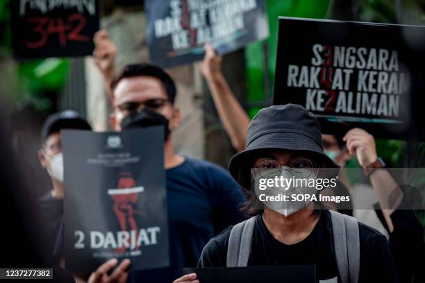 Young protesters from the Youth coalition Sekretariat Solidariti Rakyat hold placards during a rally against the amendments to the Prevention and...