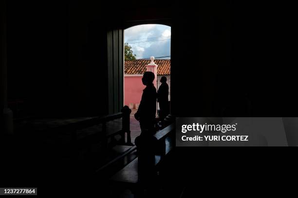 Parishioners wear protective face masks and take physical distance while attending to a mass in the parish of the populous neighborhood of Petare in...