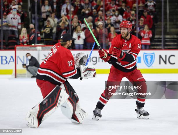 Antti Raanta of the Carolina Hurricanes and teammate Jaccob Slavin perform a Star Wars themed storm surge celebration following an NHL game victory...