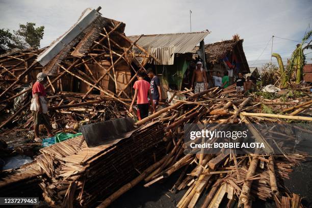 Residents salvage belongings from their destroyed homes in the coastal town of Dulag in Leyte province on December 17 a day after Super Typhoon Rai...