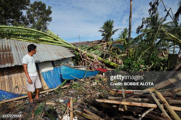 Resident looks at his damaged home in the coastal town of Dulag in Leyte province on December 17 a day after Super Typhoon Rai hit.