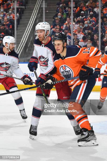 Jesse Puljujarvi of the Edmonton Oilers battles for position against Vladislav Gavrikov of the Columbus Blue Jackets on December 16, 2021 at Rogers...