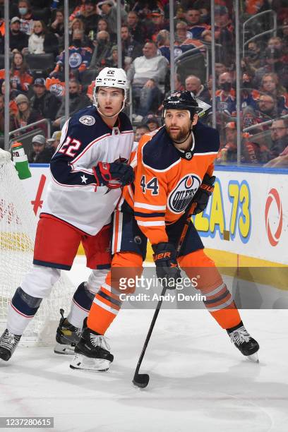 Zack Kassian of the Edmonton Oilers battles for position against Jake Bean of the Columbus Blue Jackets on December 16, 2021 at Rogers Place in...