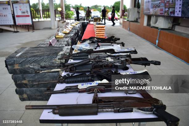 Firearms confiscated from separatist groups are presented at a press conference at the Narathiwat Provincial Police Station in the southern Thai...