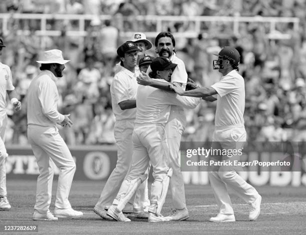 Merv Hughes of Australia gets a hug from wicketkeeper Tim Zoehrer after taking the wicket of England batsman Chris Broad during the 5th Test match...