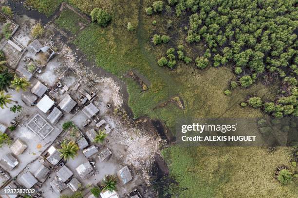 This aerial photograph taken on October 24, 2021 shows the fishing village called "Kilometers 5" surrounded by mangroves at the mouth of the Congo...