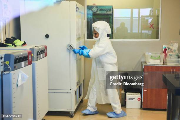 Technician wearing a full body protection suit works inside a biosafety level 3 Covid-19 research laboratory at the African Health Research Institute...