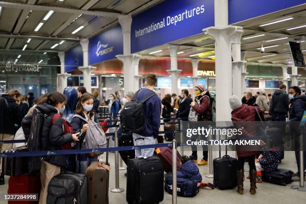 Passengers queue to board Eurostar trains at St Pancras International station in London on December 17 the final day before new restrictions are...