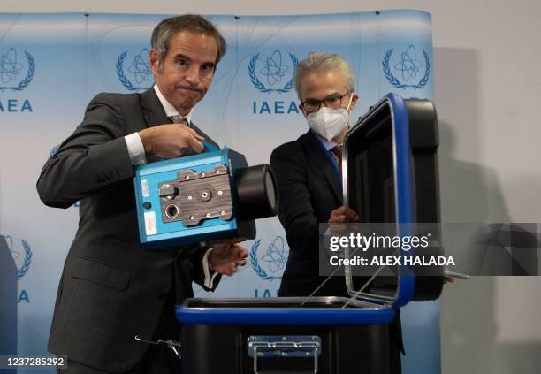 Director General of the International Atomic Energy Agency Rafael Mariano Grossi presents a surveillance camera at the agency's headquarters in...