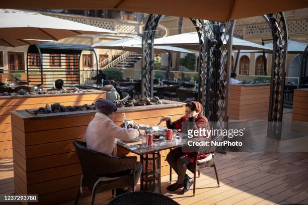 Two Iranian women eat meal at a cafe-restaurant which is located in a historical residential building near a historical church in the city of...