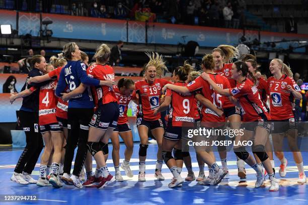 Norway's team players celebrate after winning their semi-final handball match against Spain during the IHF World Women's Handball Championship at the...