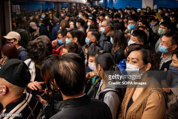 Commuters wearing facemasks are seen waiting for a subway train to arrive at a MTR station in Hong Kong. The city of Hong Kong is on high alert as a...