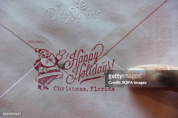 Christmas card is seen in Orlando, bearing a rubber stamped message from the nearby Christmas, Florida post office. Each year, thousands of people...