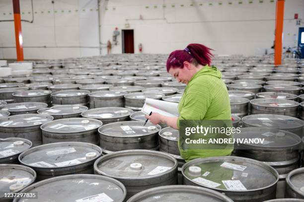 An employee helps to identify and sort empty barrels returned by producers at one of two maple syrup reserves at the Quebec Maple Syrup Producers...