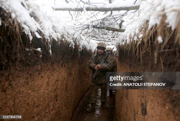 Ukrainian servicemen walk in a trench on their position on the front line with Russia-backed separatists near small town of Svitlodarsk, Donetsk...
