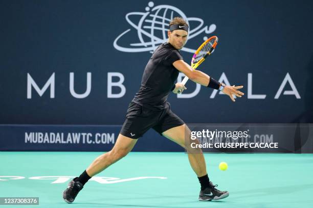 Spain's Rafael Nadal returns the ball to Canada's Denis Shapovalov during the third-place play-off match of the Mubadala World Tennis Championship in...