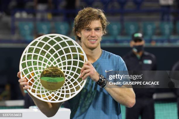 First-place winner Andrey Rublev of Russia holds up his trophy during the awards ceremony after the final match of the Mubadala World Tennis...