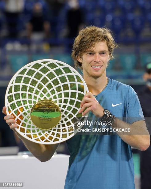 First-place winner Andrey Rublev of Russia holds up his trophy during the awards ceremony after the final match of the Mubadala World Tennis...