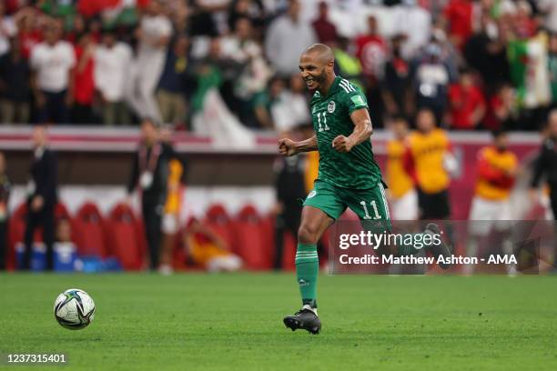 Yacine Brahimi of Algeria celebrates before scoring a goal to make it 0-2 the FIFA Arab Cup Qatar 2021 Final match between Tunisia and Algeria at Al...