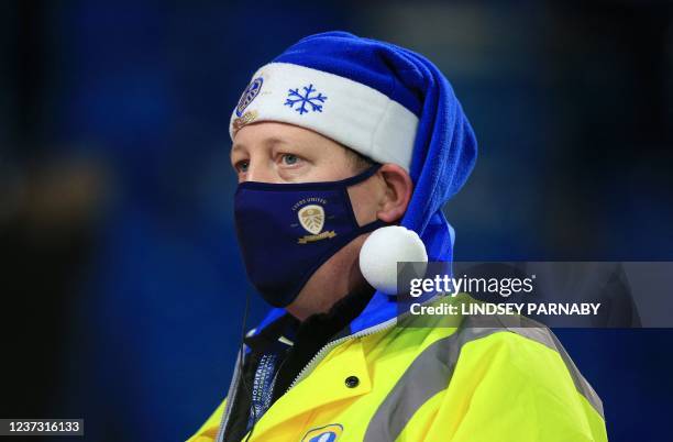 Steward wearing a face mask and a Christmas hat looks on during the English Premier League football match between Leeds United and Arsenal at Elland...