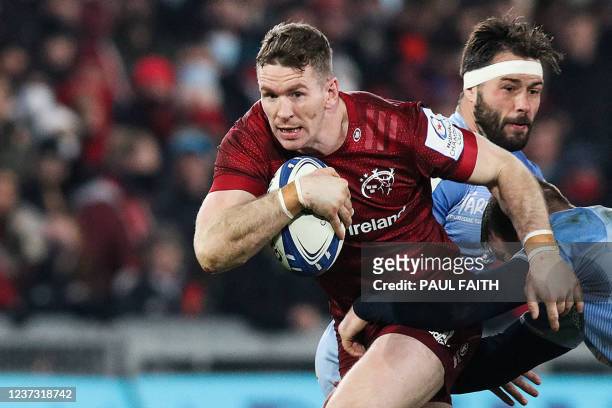 Munster's Irish centre Chris Farrell is tackled by Castres' French flanker Kevin Kornath during the European Rugby Champions Cup 2nd round day pool B...