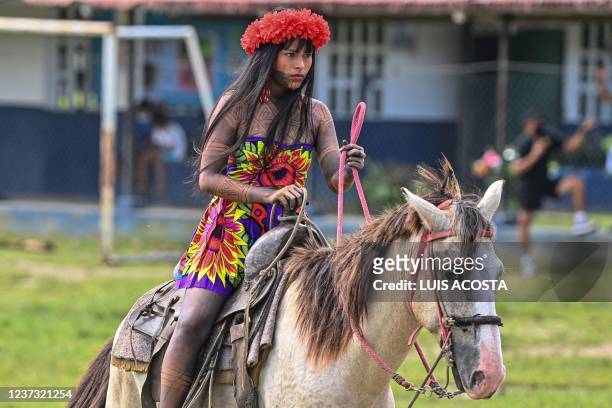 Panamanian Embera indigenous woman rides a horse during a break at the third Ancestral Indigenous Games in Pueblo Nuevo Buri, province of Bocas del...