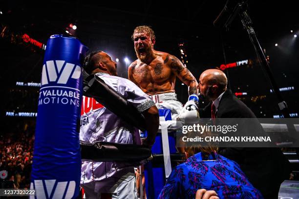 YouTube personality Jake Paul celebrates after knocking out former UFC welterweight champion Tyron Woodley in an eight-round cruiserweight bout at...