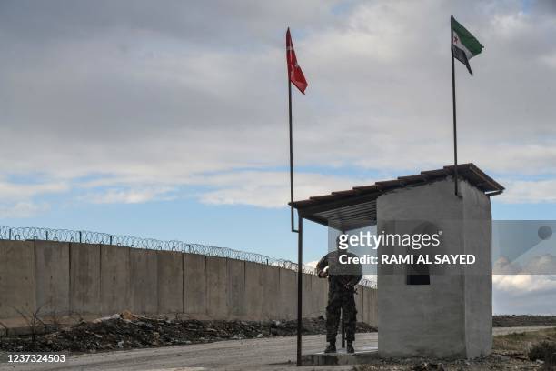 Member of Turkish-backed Free Syrian Army mans a checkpoint near the village of Jindayris in the countryside of Afrin, along the wall on the northern...