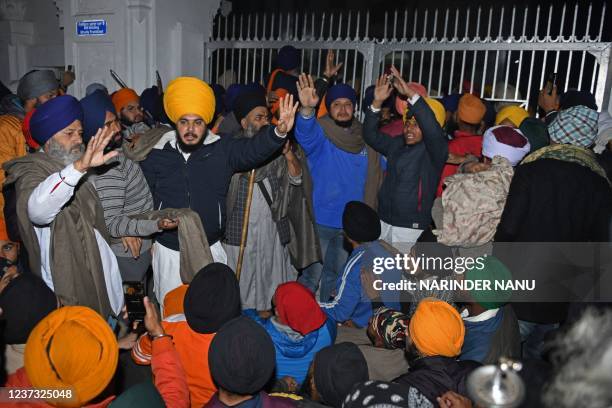 In this picture taken on December 18 Sikh youths gather outside the Teja Singh Samundri Hall after a man was beaten to death for allegedly trying to...