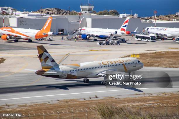 Etihad Airways Airbus A320 aircraft as seen taxiing, departing and flying from Mykonos Airport JMK. The airplane with registration A6-EIU takes the...