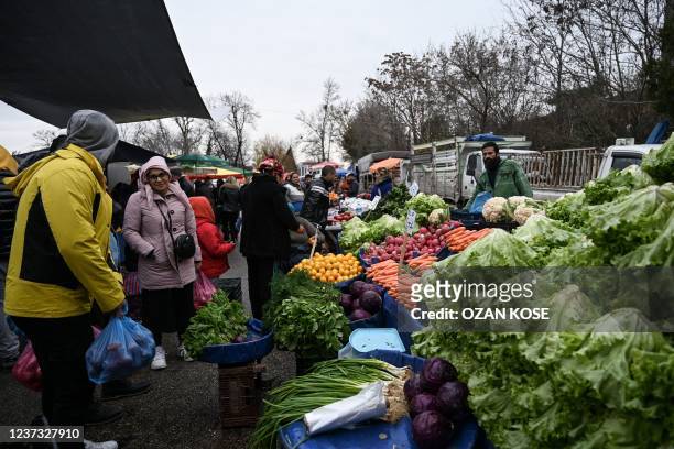 Tourists shop vegetables at a bazaar in Edirne, near Bulgaria border in Turkey on December 17, 2021. - The mosque-filled city of Edirne was an early...