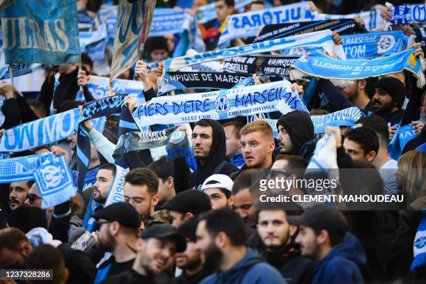 Supporters cheer on their team as they attend the French Cup round-of-64 football match between Olympique de Marseille and ES Cannet-Rocheville at...