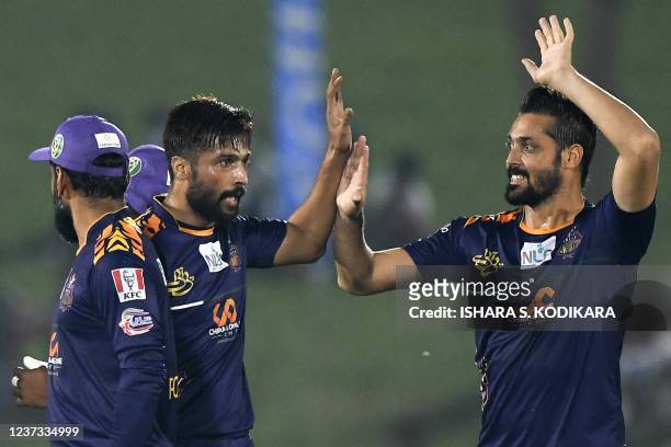 Galle Gladiators' Mohammad Amir celebrates with teammates after the dismissal of Jaffna Kings' Avishka Fernando during the Lanka Premier League...
