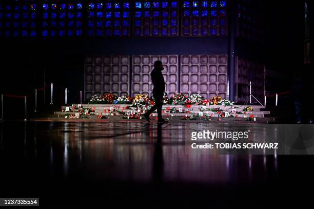 Man walks past the memorial for the victims of the terror attack at the Breitscheidplatz square Christmas market in Berlin prior a ceremony to...