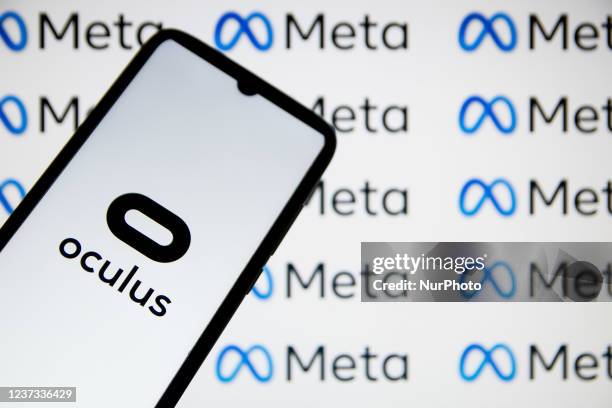 In this photo illustration an Oculus VR logo seen displayed on a smartphone with Meta logos in the background in Athens, Greece on December 19, 2021.