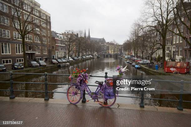 Decorated bycicle on a bridge of a canal on December 19, 2021 in Amsterdam, Netherlands. Starting today, bars, gyms, hair-dressers and other...