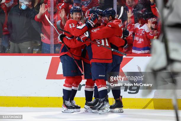 Connor McMichael, Beck Malenstyn, Martin Fehervary and Joe Snively of the Washington Capitals celebrate a first period goal during a game against the...