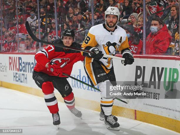 Yegor Sharangovich of the New Jersey Devils skates against Kris Letang of the Pittsburgh Penguins during the first period at the Prudential Center on...