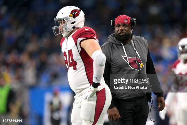Arizona Cardinals defensive line coach Brentson Buckner talks to defensive end Zach Allen during the first half of an NFL football game against the...