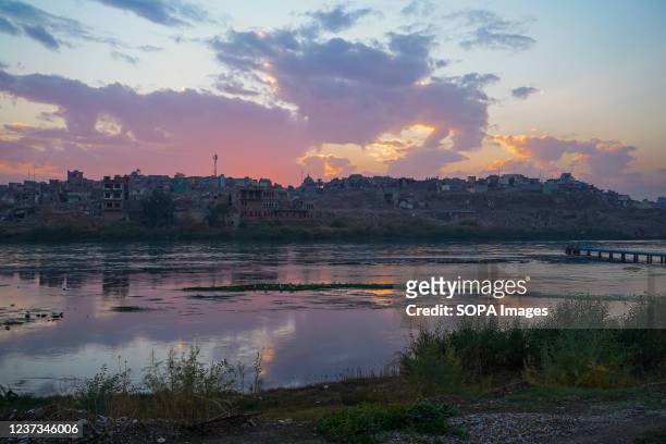Sunset behind the old area along Tigris River in the northern Iraqi city of Mosul.