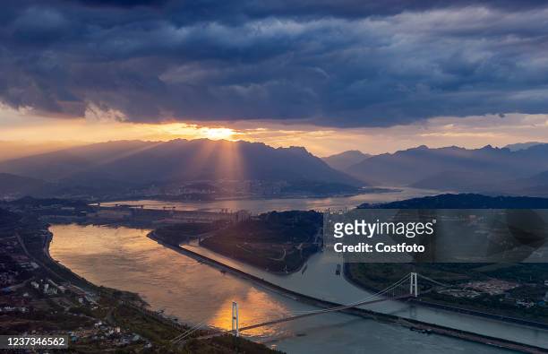 Sun breaks through dark clouds to illuminate the Three Gorges Dam in Yichang, Hubei Province, China, April 15, 2021.