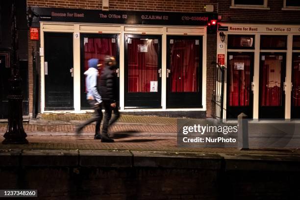 People are walking by the empty displays of Red Light district. Streets of Amsterdam during the first day of the sudden lockdown in Dutch capital...