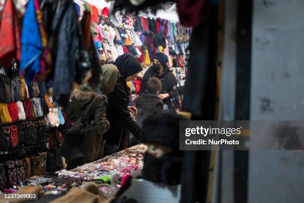 Iranian women at a hat and scarf shop in the city of Isfahan, 450 km south of Tehran, at night on December 14, 2021. A spokesman for Isfahan...