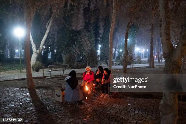 An Iranian family sit around the fire in a park near a dried-up Zayandeh Rud river riverside in the city of Isfahan, 450 km south of Tehran, at night...