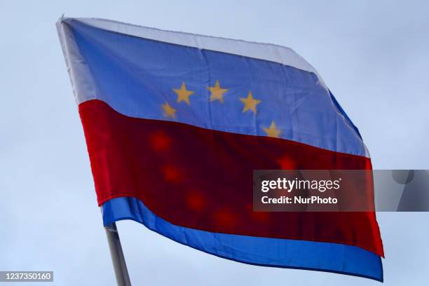 Polish and EU flags are seen during 'Free People, Free Media' protest at the Main Square in Krakow, Poland on December 19, 2021. Protesters gathered...