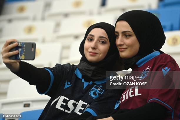 Trabzonspor fans take pictures during the Super league football match between Trabzonspor and Hatayspor at the Medical Park Stadium in Trabzon, on...