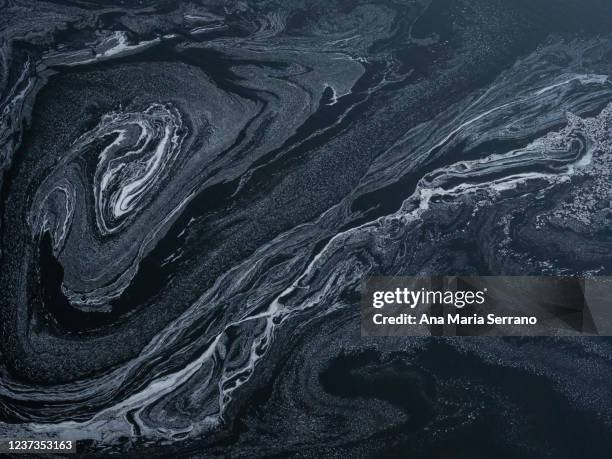 foam on the water surface of a river - dark marble stock pictures, royalty-free photos & images