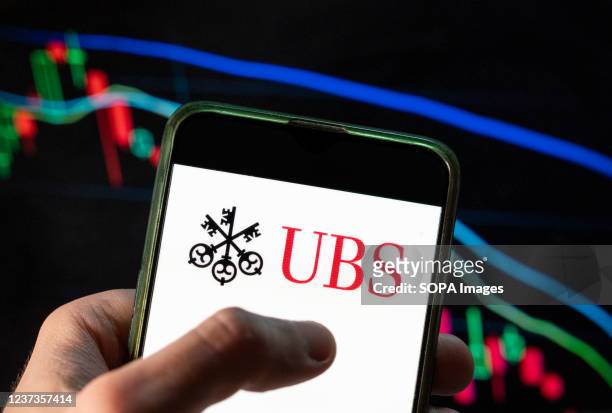 In this photo illustration the Swiss multinational investment bank and financial services company UBS Group logo seen displayed on a smartphone with...